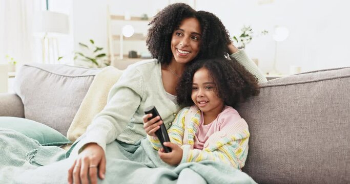 Watching tv, mother and daughter, sofa and home living room with remote, bonding and comedy in morning. Woman, girl child and television for cartoon, movies and streaming subscription on lounge couch