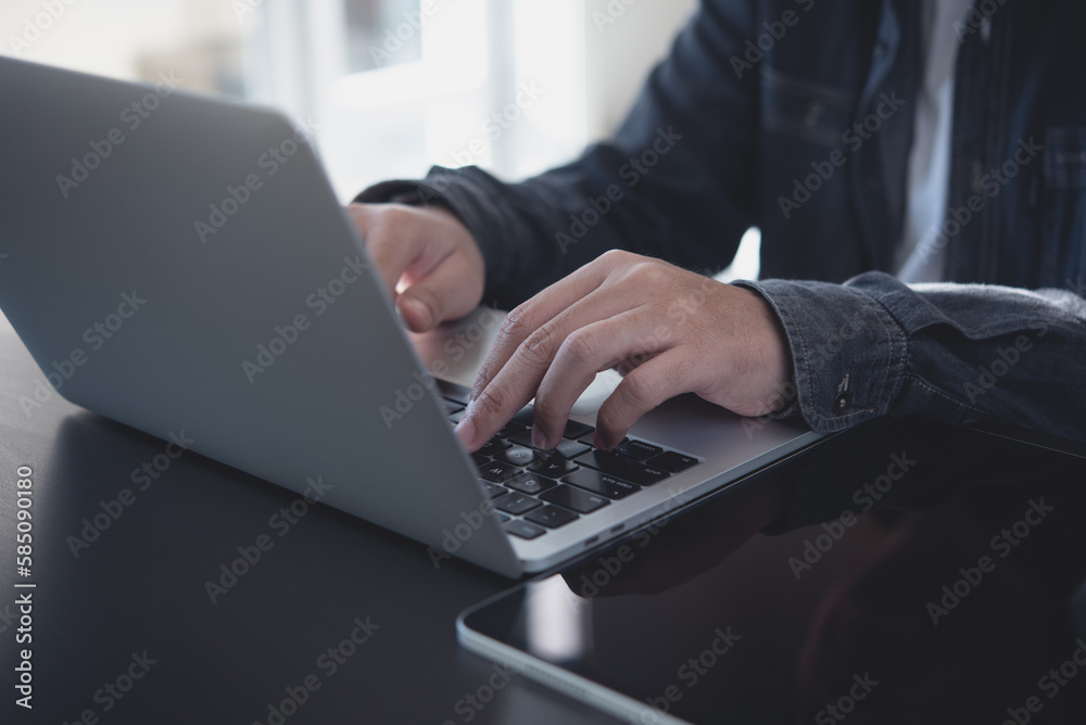 Wall mural business man hands typing on laptop computer keyboard and surfing the internet on office table, onli