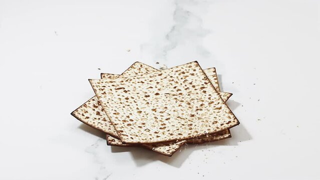 Passover Matzah breaking, slow motion video. Kosher Matzah or  Matzot -  symbolic of the Jewish holiday Passover known in Israel as Pesach