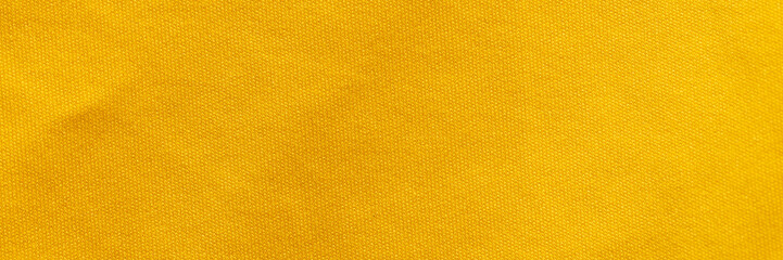 Yellow color sports clothing fabric football shirt jersey texture and textile background, wide banner.