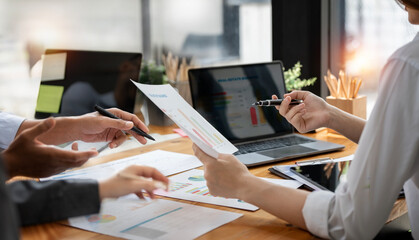 Business People Meeting using laptop computer and graph chart calculating stock market and analysis Plans to improve quality. Conference Discussion Corporate Concept.