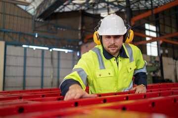 Steel worker performing quality control of manufactured products in a warehouse