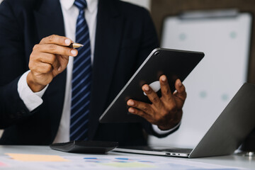 Attractive smiling young asian business woman work at home office, Asian woman working on laptop computer holding tablet.