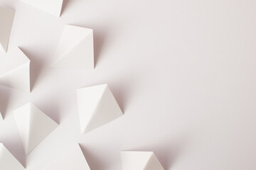 White geometric shapes on white background with copy space