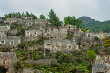 Fototapeta na wymiar Abandoned Greek village in Turkey. Stone houses and ruins of Fethiye Kayakoy.