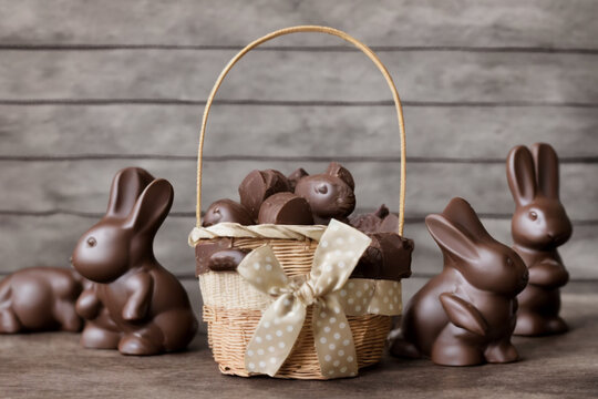 Beautiful basket with beige ribbon with white polka dots and Easter 2023 chocolate bunnies