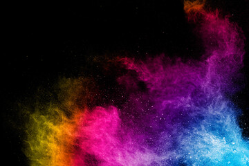Colorful background of pastel powder explosion.Rainbow color dust splash on black background.