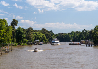 Mahogany boats ferry passengers from the port to their homes and landing stages on Parana delta in Argentina