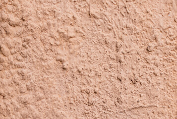 Abstraction. Texture of cement plastered and painted wall in pale pink color closeup