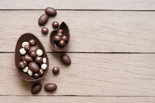 Chocolate day with chocolate egg and sweets on beautiful wooden background
