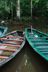 Amazon boats at Sandoval Lake in Amazonas Puerto Maldonado Peru. Wood boats on the water inside jungle rainforest. Selective focus.