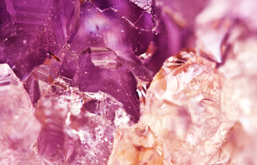 Purple background of amethyst crystals closeup