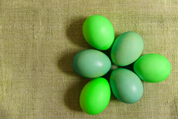 Paint eggs for Easter, bright Easter holiday, children paint eggs, colored eggs in a basket, colored eggs on a stand, Holiday background 