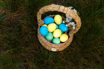 Fototapeta na wymiar Paint eggs for Easter, bright Easter holiday, children paint eggs, colored eggs in a basket, colored eggs on a stand, Holiday background 