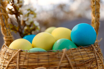 Paint eggs for Easter, bright Easter holiday, children paint eggs, colored eggs in a basket, colored eggs on a stand, Holiday background 