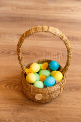Paint eggs for Easter, bright Easter holiday, children paint eggs, colored eggs in a basket, colored eggs on a stand, Holiday background 
