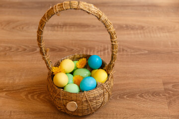 Paint eggs for Easter, bright Easter holiday, children paint eggs, colored eggs in a basket, colored eggs on a stand, Holiday background 