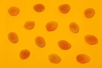 Dried apricots on a yellow background. Dried apricot.
