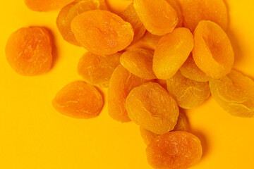 Dried apricots on a yellow background. Dried apricot.
