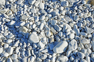 Marble pebbles of different sizes on the beach