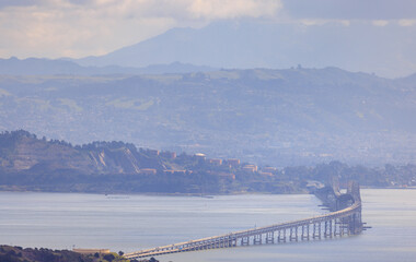 Richmond - San Rafael Bridge curves over San Francisco Bay on hazy day