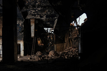 Burnt and ruined interior of industrial building after fire. Consequences of war, fire or other...