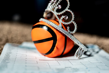 Basketball, tiara, and blank bracket signifying a Cinderella season.