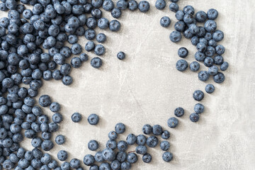 Fresh blueberries on gray background. Blueberries background. Healthy berry, organic food, antioxidant, vitamin, blue food.