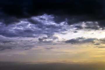 Fototapeta na wymiar Dark cloudy sky with sunlight background. Cloudscape background. Dramatic sky with dark fluffy clouds background. 