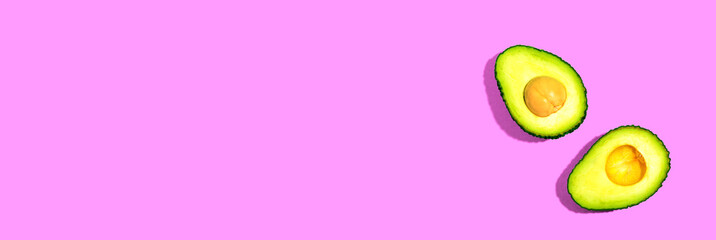 Fresh avocado halves overhead view - flat lay