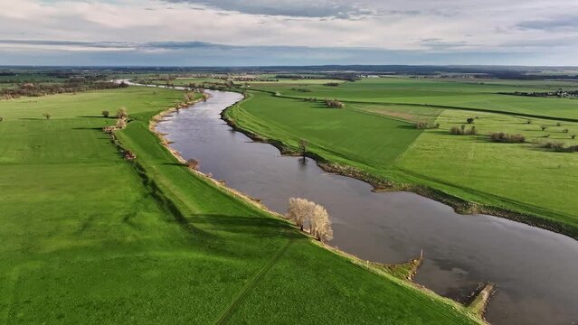 river elbe in sunlight. clear sky after the rain. green fields in spring
