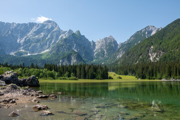 View of the turquoise waters of Lago die Fusine Superiore in the Julian Alps of northeastern Italy...
