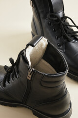 boots with studded soles, winter or demi-season shoes made of black leather with special retractable studs on the sole