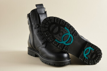 boots with studded soles, winter or demi-season shoes made of black leather with special retractable studs on the sole