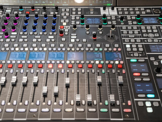 Sound audio mixer of sliders and buttons on a console with connected audio jacks