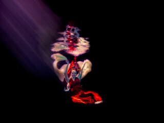 Obraz premium Patty underwater in long red dress