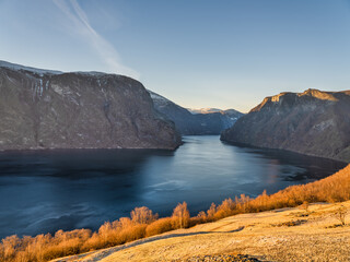 Aurlandsfjord, brown trees and yellow grass on mountain sunset during autumn season in Vestland,...