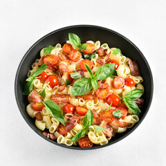 Tomato and bacon pasta in cooking pan