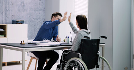 Businesswoman With Disability Giving High Five To Her Partner