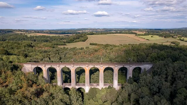 Overpass for train in the forest, Timelapse with movements of clouds.