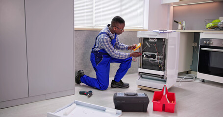 African American Repairman Fixing Dishwasher Appliance