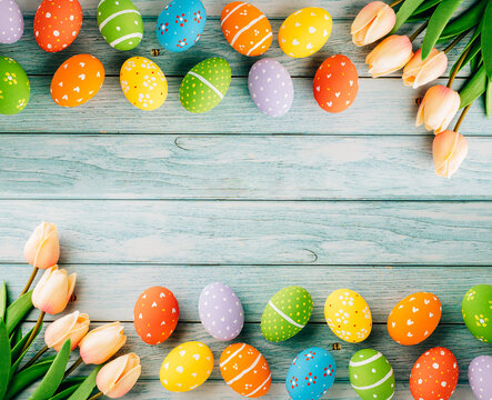 Happy Easter Day Concept. Flat Lay Holiday Banner Background Web Design White Colorful Easter Eggs Painted With Tulips Flowers On Blue Wood Background With Empty Copy Space, Overhead, Template