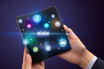 Businessman holding a foldable smartphone