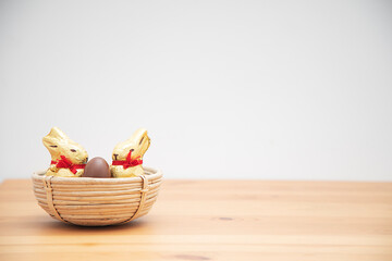 Two easter bunnies with chocolate eggs. Easter background.