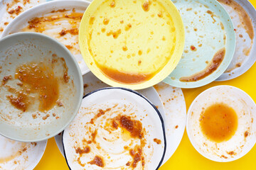 Dirty dishes on yellow background. Top view