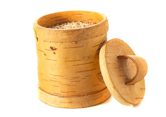 oats are poured into birch bark containers for storage