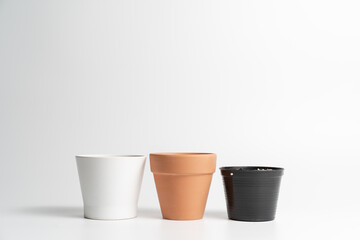 Various pot comparison in isolated white background. Ceramic, Terracotta and Plastic pots comparison