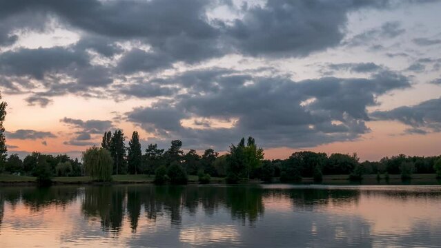 Pink Sunset Timelapse above a lake with reflection, Châteauroux, France,