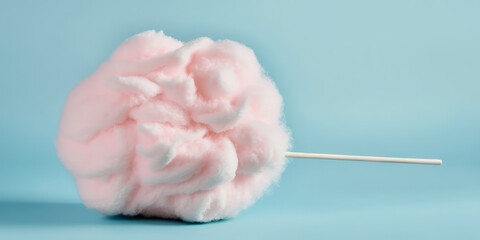 Stick with yummy cotton candy isolated on flat lay pastel pink background. Cute concept. Sweet sugar cotton candy pink color. Copy space for text, banner template. Generative AI art.