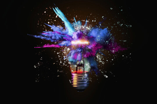 Creative colored light bulb explosion with shards and paint, a creative idea. Think different, concept. Business, ideas and the discovery of new technology